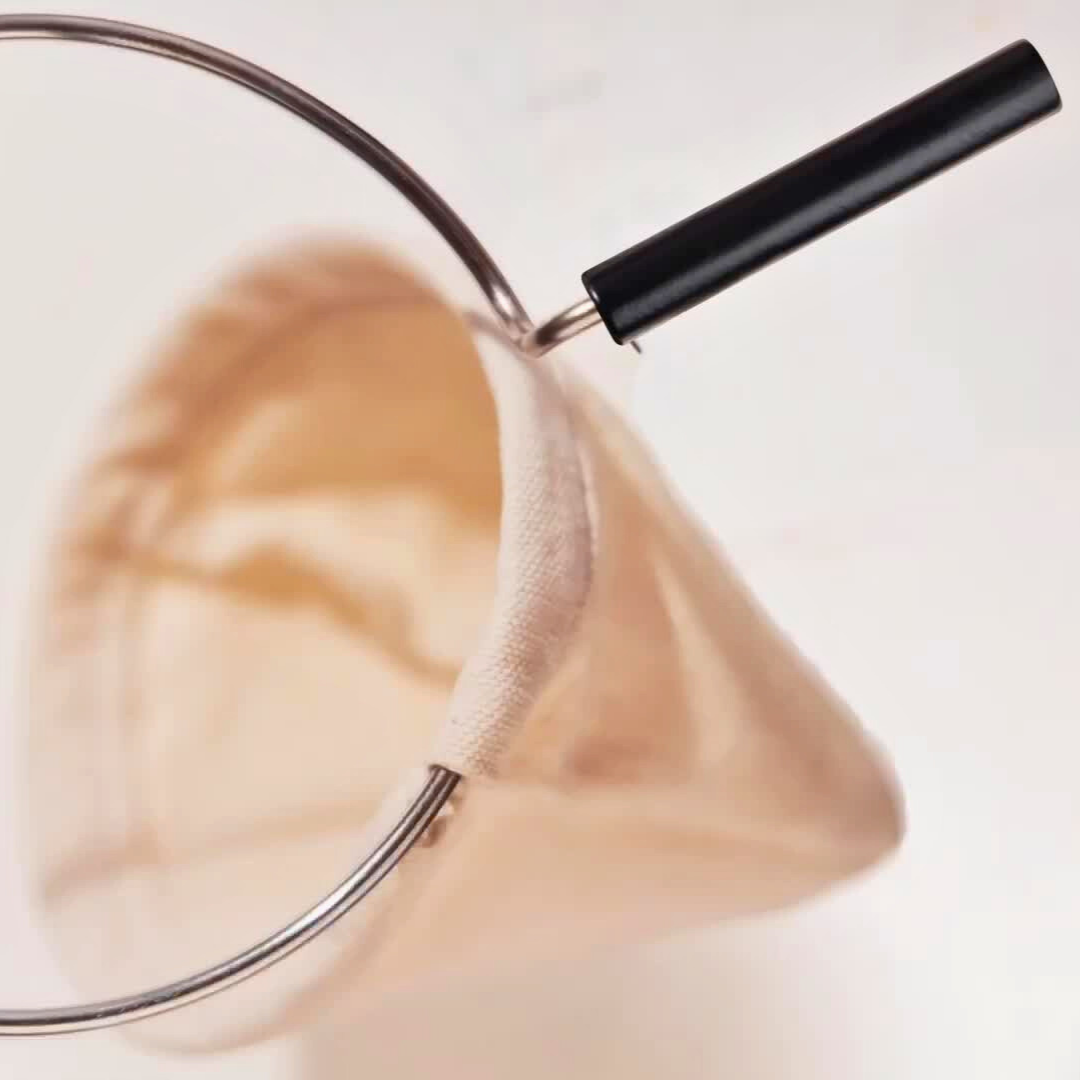 A Plinc cloth filter with a metal ring and handle.
