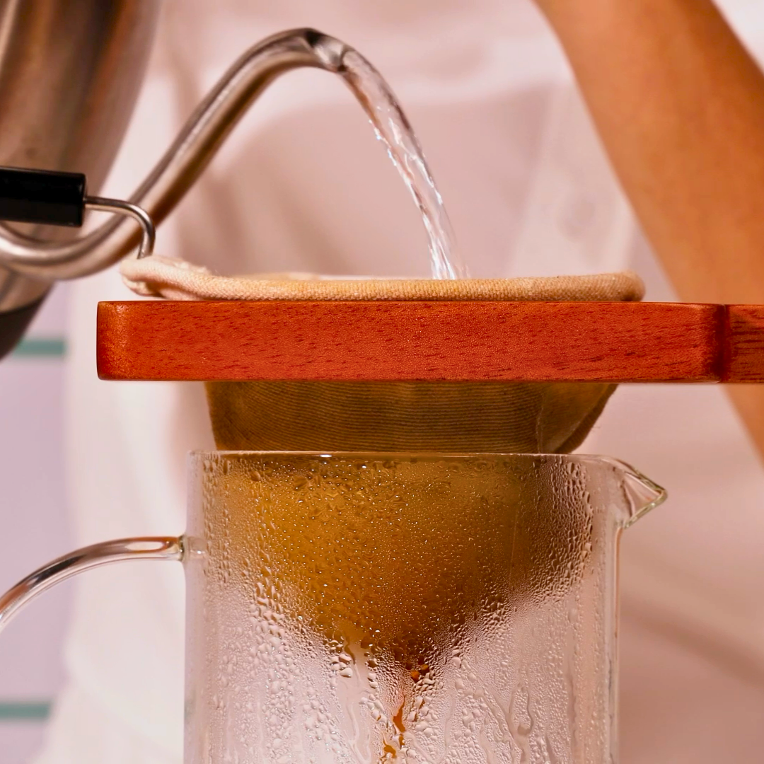 Brewing coffee with the Plinc cloth filter over a carafe.